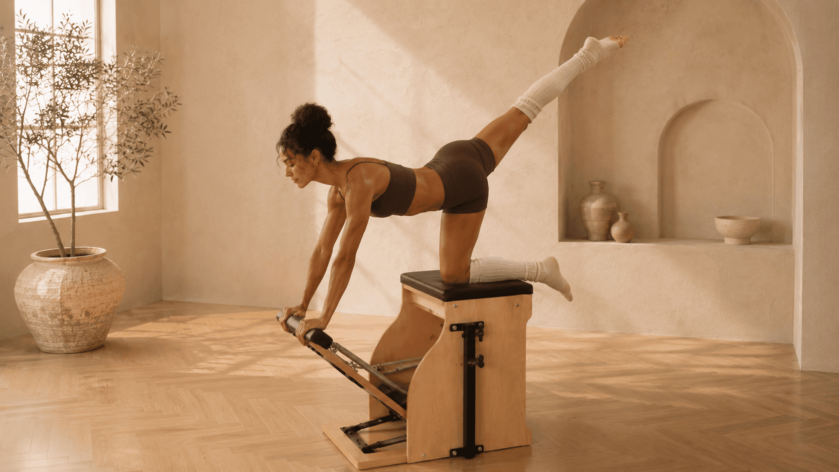 A dancer-like arabesque balanced on the studio chair, framed by plaster arches.