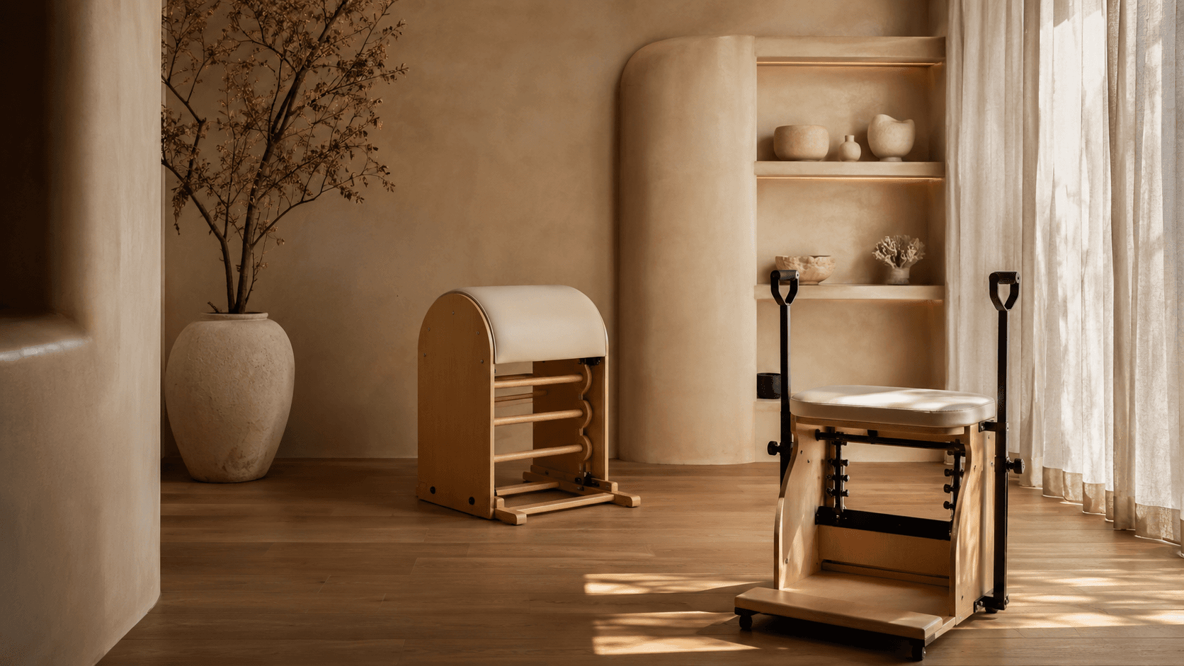 A ladder barrel and studio chair arranged beside shelves of pale ceramics.